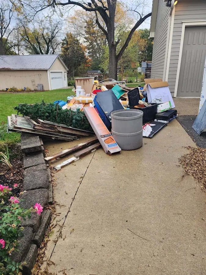 Dumpster being loaded with debris for Estate Cleanout Dumpster Rental in Winter Garden